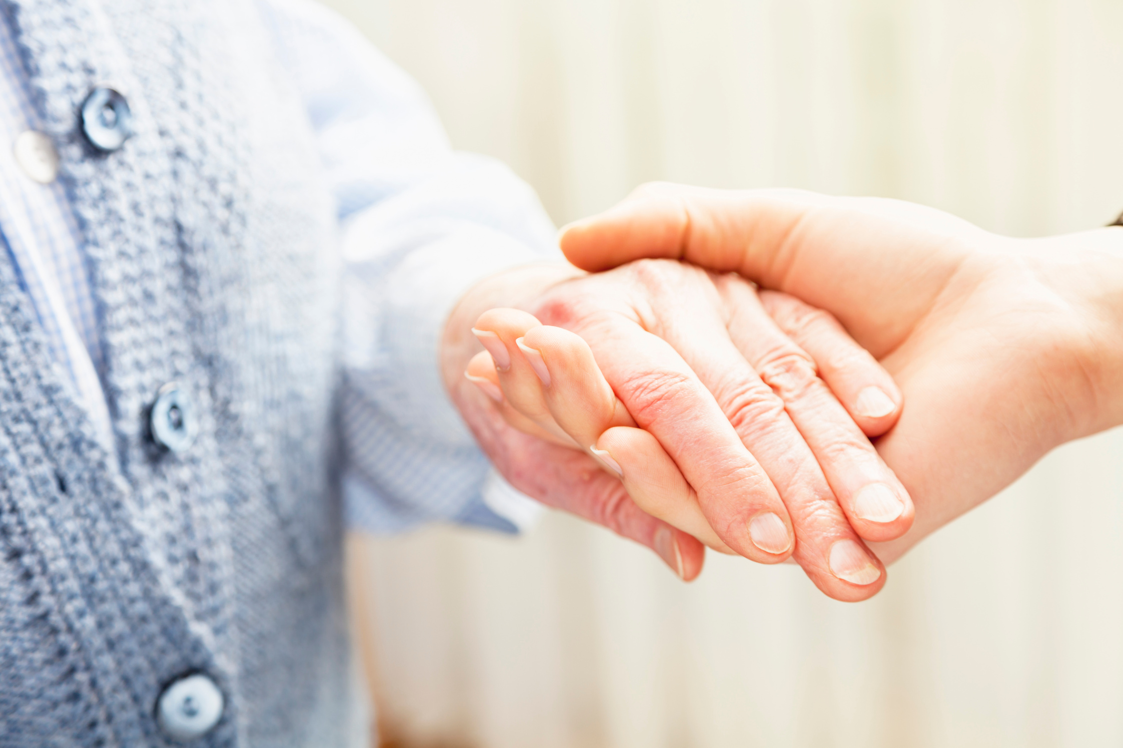 young woman  holding old persons  hand care